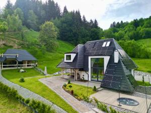 a house with solar panels on its roof at Sol Chalet Maramures in Borşa
