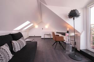 a living room with a couch and a table at Bed & Breakfast La Linière in Brussels