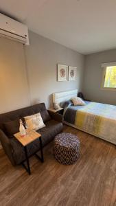 a living room with a couch and a bed at Son Veri LUXURy HOME in Cala Blava