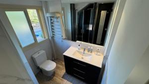 a bathroom with a sink and a toilet and a mirror at Son Veri LUXURy HOME in Cala Blava +5 photos