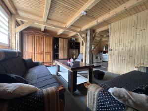 a living room with two couches and a table at Mirno mjesto in Mujakovići