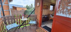 a porch of a house with a red door at Tiny House An der Pferdekoppel in Groß Garz