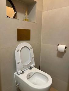 a bathroom with a toilet with the seat up at Rum Horizon Camp& Tours in Wadi Rum +53 photos
