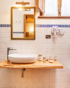 a bathroom with a white sink and a mirror at Podere Sant'Elena in San Gimignano +55 photos