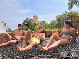 a group of people sitting on top of a roof at Punta Kai Hotel & Hostal in Puerto Escondido