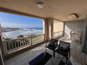 a room with a balcony with a view of the ocean at Laguna La Crete 33 in Uvongo Beach