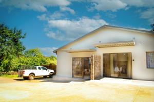a white truck parked in front of a house at Jac-Marie guests accommodation in Tzaneen