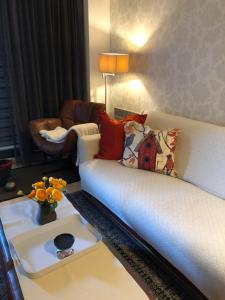 a living room with a white couch and a table at les terrasses2 in Ostend