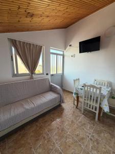 a living room with a couch and a table at Villa DEA in Velipojë