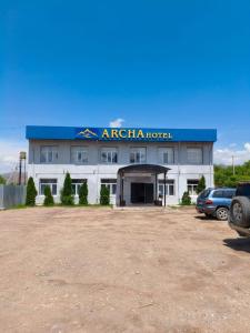 aania hotel with cars parked in front of it at Archa Hotel Kochkor in Kochkorka