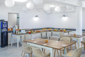 a restaurant with tables and chairs and a counter at Villa My Garden in Zamárdi