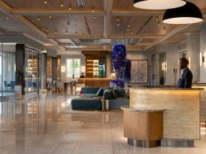 a man standing at a bar in a lobby at Four Seasons Hotel The Westcliff in Johannesburg +62 photos