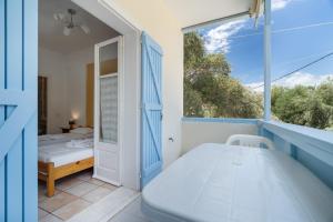 a small bedroom with a bed and a window at Villa Milia 2 in Agios Nikitas