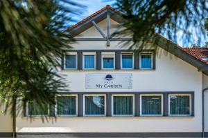 a white building with a sign for the my church at Villa My Garden in Zamárdi +9 photos