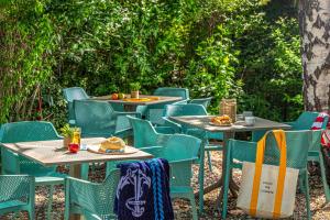 a group of tables and chairs with food on them at Villa My Garden in Zamárdi