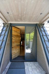 a pivot door on the side of a house at Chalet NATURTRAUM in Runkel +31 photos