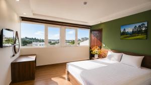 a bedroom with a white bed and green walls at Lien's 2 Hotel Dalat in Da Lat +53 photos
