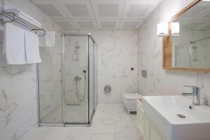 a bathroom with a shower and a sink and a toilet at ADIYAMAN PARK HOTEL in Adıyaman +11 photos