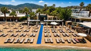 an aerial view of a beach with chairs and umbrellas at Mercans Bodrum Beach Hotel in Bodrum City
