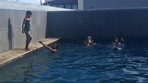 a group of people in the water in a swimming pool at Hora Quente in Windhoek +18 photos