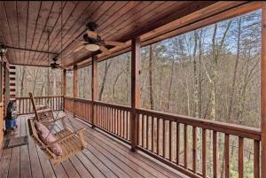 a porch with a rocking chair and a ceiling fan at Pet-Friendly Mountain Heaven - Hot Tub and Fire Pit in Blue Ridge