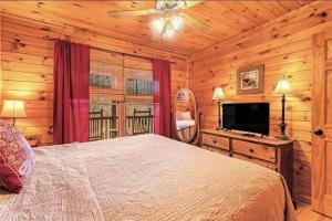 a bedroom with a bed and a flat screen tv at Pet-Friendly Mountain Heaven - Hot Tub and Fire Pit in Blue Ridge