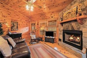 a living room with a fireplace in a log cabin at Pet-Friendly Mountain Heaven - Hot Tub and Fire Pit in Blue Ridge