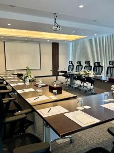 a conference room with tables and chairs and a projection screen at Sedra Al Alami Jeddah in Jeddah +31 photos