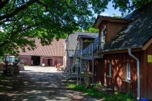 a building with a staircase next to a house at Hof Bahrenwinkel in Osterholz-Scharmbeck
