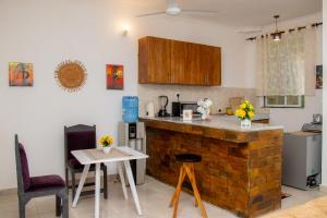a kitchen with a counter and a table and chairs at Bamburi BnB in Mombasa