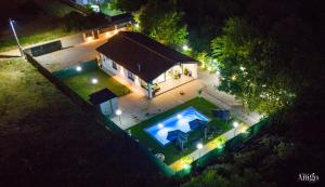 an aerial view of a house at night with a swimming pool at Holiday Home Nova Lux in Mostar