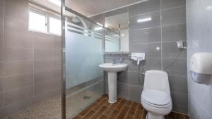a bathroom with a toilet and a sink and a mirror at Jeju seawalk in Namwon +23 photos