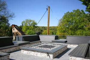 a patio with benches and a fire pit on a roof at Chalet NATURTRAUM in Runkel