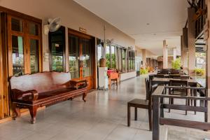 a store with tables and benches in a building at Thanawong Pool Villa in Sukhothai