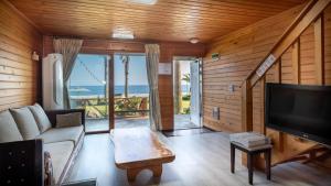 a living room with a couch and a tv at Jeju seawalk in Namwon