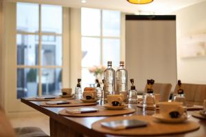 a long wooden table with bottles on top of it at Boutique Hotel Elburg met Tapperij in Elburg