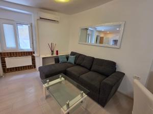 a living room with a couch and a mirror at Breece Hideaway in Piran