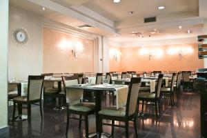a restaurant with tables and chairs in a room at Millennhotel in Bologna