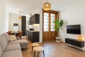 a living room with a couch and a table at Boho Apartments - 2 Bedrooms in Antwerp