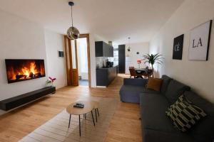 a living room with a couch and a fireplace at Boho Apartments - 2 Bedrooms in Antwerp