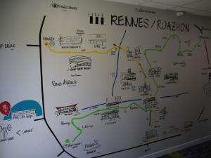 a map on a wall with drawings on it at ibis budget Rennes Rte Lorient in Rennes