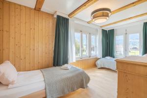 a bedroom with two beds and green curtains at Hasel in Interlaken