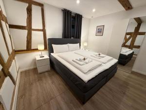 a bedroom with a bed with two towels on it at JURAFLAIR Apartments in Lichtenfels