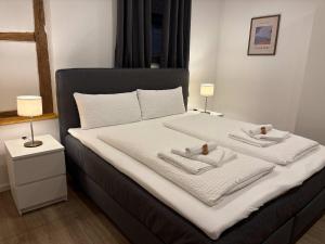 a bedroom with a bed with two towels on it at JURAFLAIR Apartments in Lichtenfels +15 photos