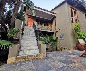 a house with stairs in front of it at Moonflower Cottages in Johannesburg