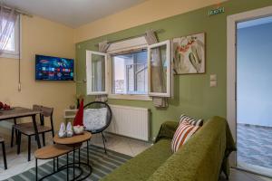a living room with a couch and a table at 50 Cube - Mountain Nook Karpenisi in Karpenisi
