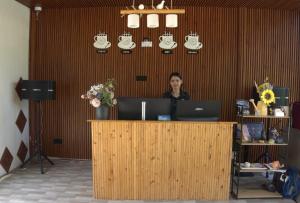 a woman sitting at a counter with a laptop at Sunny Pavilion Thoddoo in Thoddoo