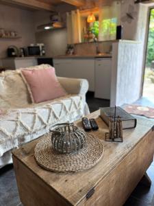 a coffee table in a living room with a couch at Gîte de Corbion une envie d'Ailleurs 6personnes et le Pt Bonheur 2 personnes in Leignon