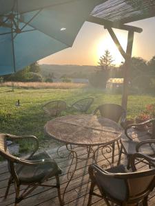 a table and chairs and an umbrella on a patio at Mont Blanc in Meyrals