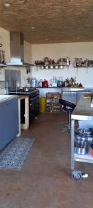 a large kitchen with a counter and a table in it at Mont Blanc in Meyrals